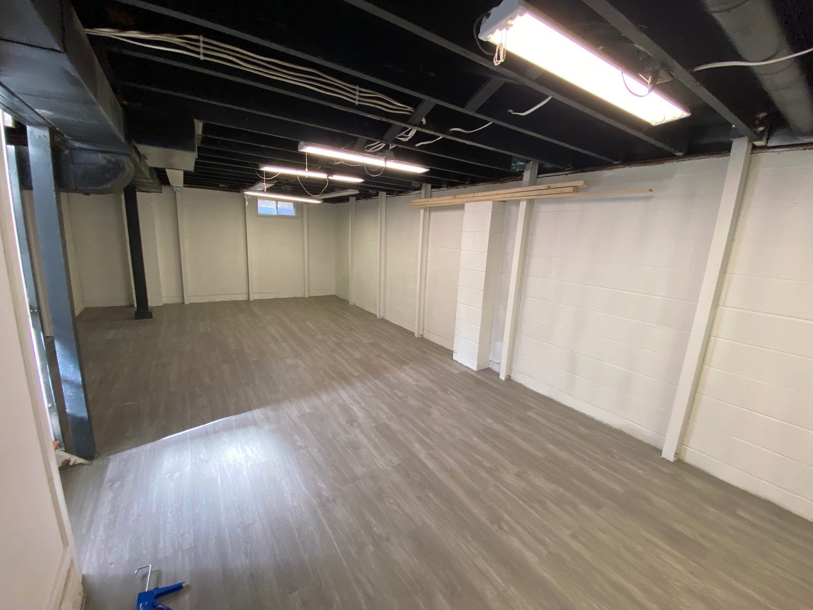 Finished basement with new flooring and fresh paint
