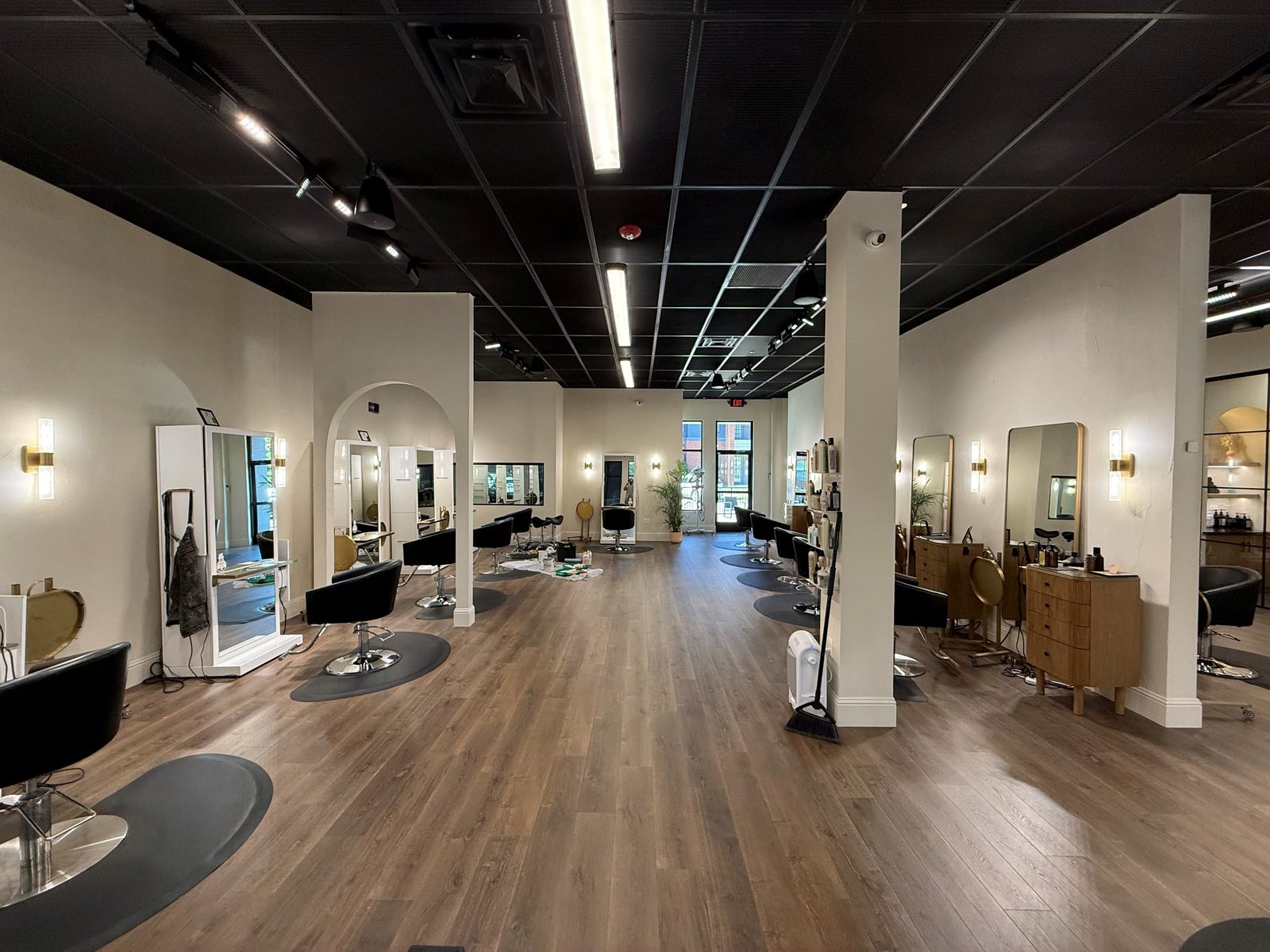 Rhi and Co salon build-out with styling stations and wood flooring
